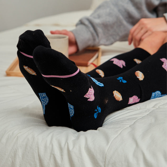 Knee-high black compression socks with colorful sports-themed patterns and pink accents.