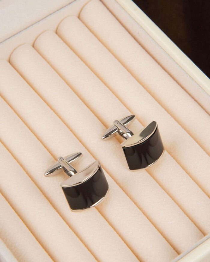 Black enamel rectangular cufflinks with curved silver-tone tops, close-up