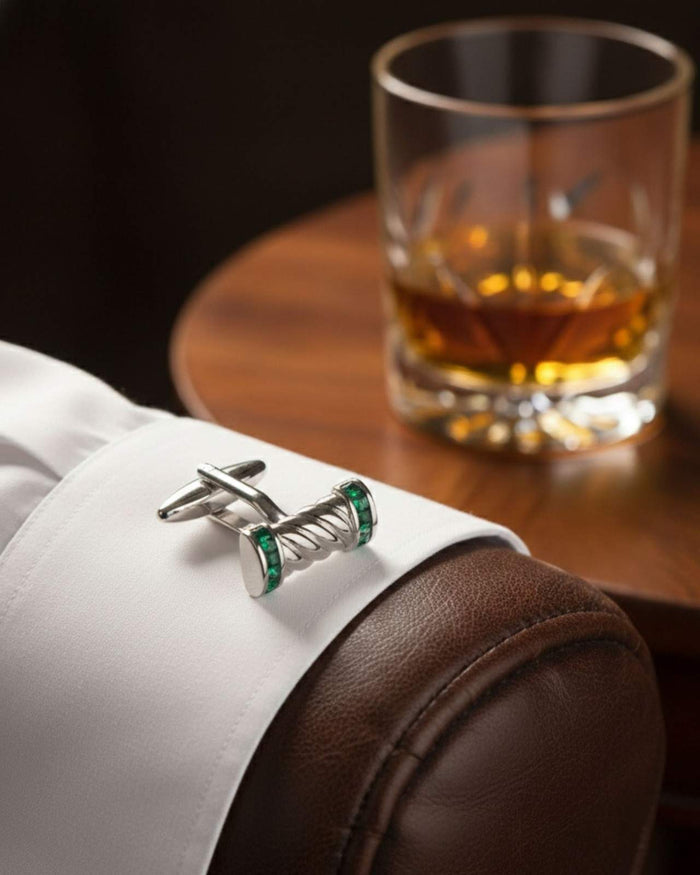 Twisted bar cufflinks on a white shirt cuff with green crystal end caps
