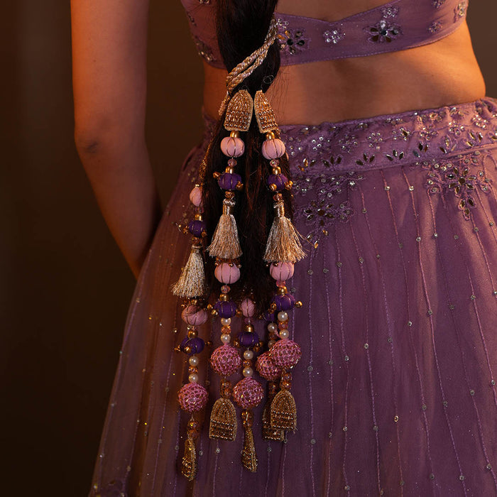 Festive hair parandi featuring layered pearls, crystals, tassels and soft ghungroo accents