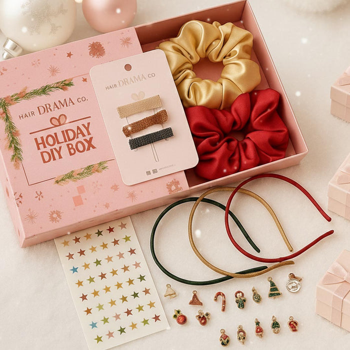 Hair Drama Co. Holiday DIY box with scrunchies, hairbands, and decorative items on a light background