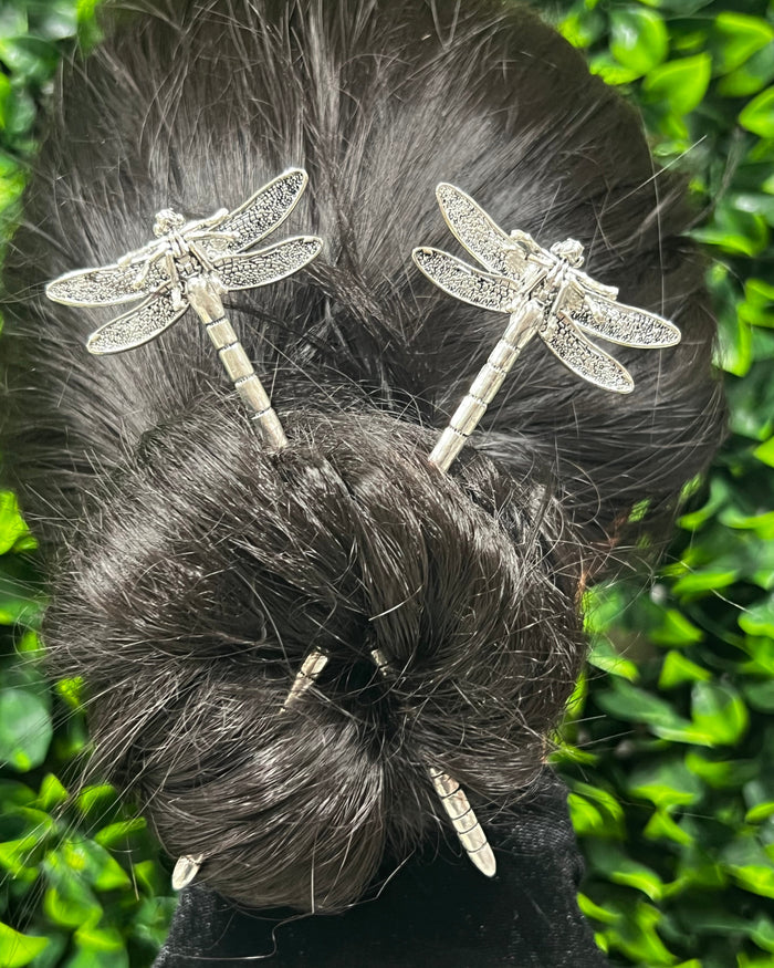 Model wearing Dragonfly Hair Sticks with delicate dragonfly design securing a bun hairstyle.