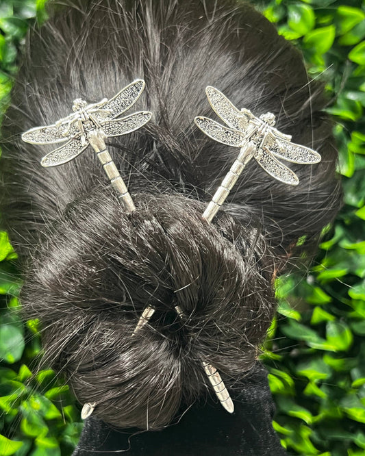 Model wearing Dragonfly Hair Sticks with delicate dragonfly design securing a bun hairstyle.
