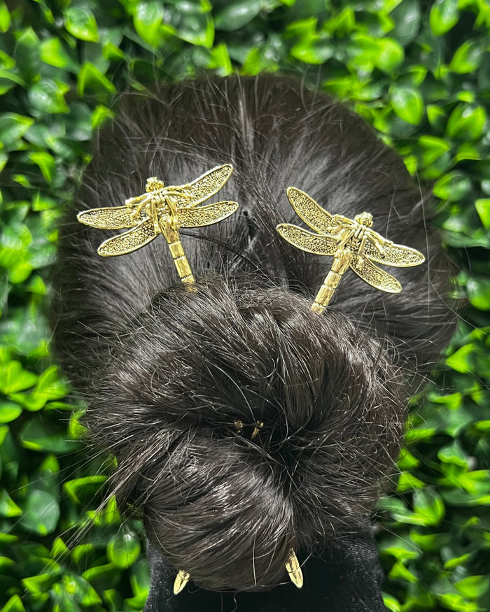 Model wearing gold Dragonfly Hair Sticks in a twisted bun hairstyle, decorative hair accessories shown from the back.