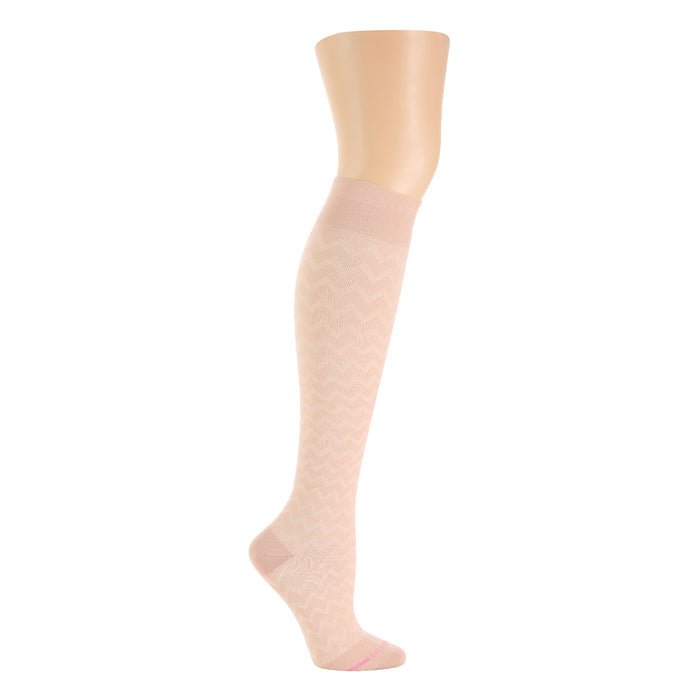 Knee-high compression sock in a light pink color with a chevron pattern and a solid cuff.