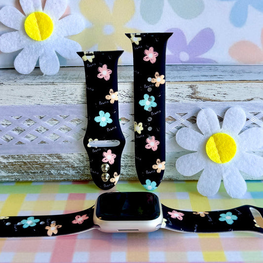 Flower Pop Apple Watch band with pastel flowers in pink, yellow, turquoise, and peach on black background with daisy decorations