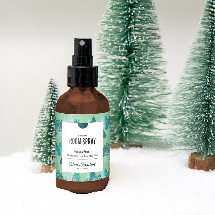 Room spray bottle labeled 'Forest Fresh' with decorative trees in the background