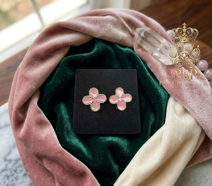 Pink floral earrings on a black card with a pink and green fabric background