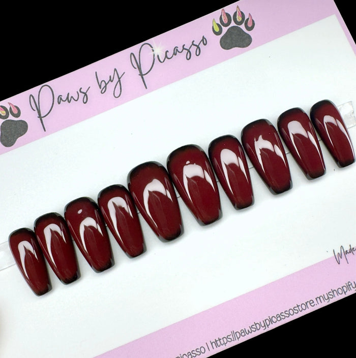 Set of dark red nail art designs on a white card with 'Paws by Picasso' branding.