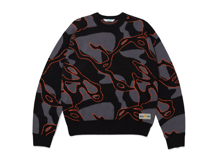 A crewneck sweater featuring a black and gray abstract camouflage pattern with thin orange contour line details, displayed flat against a white background.