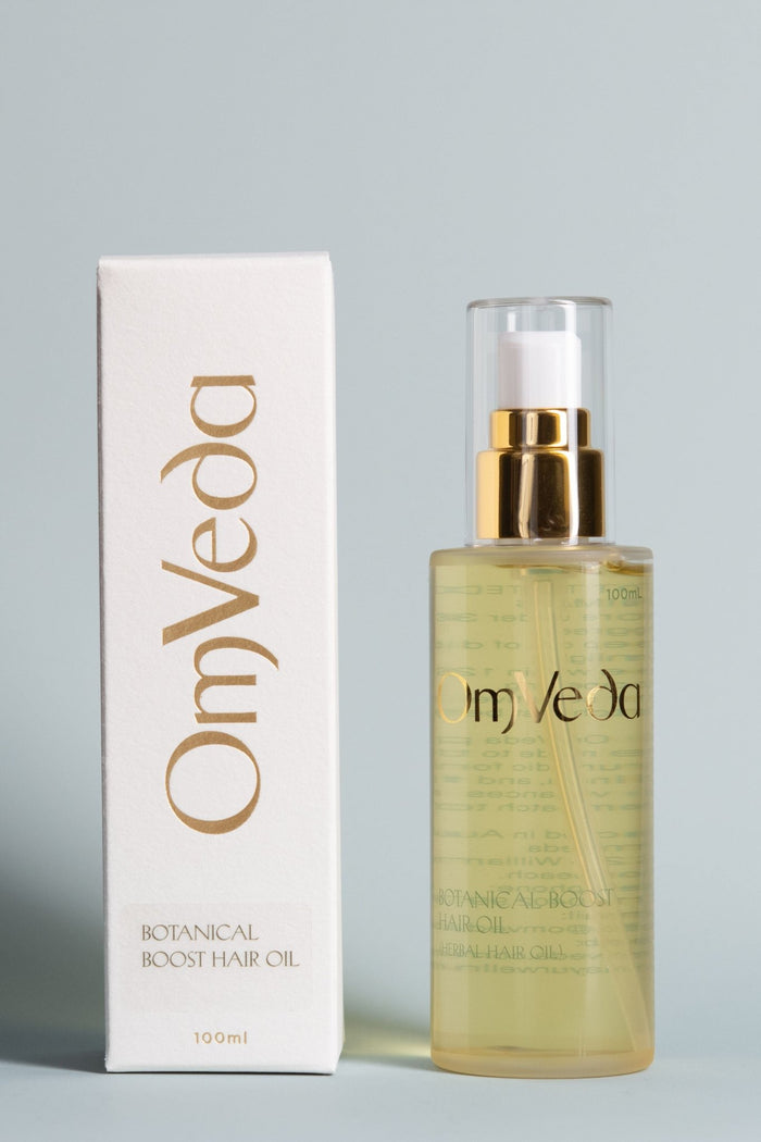 OmVeda Botanical Boost hair oil bottle with gold pump and matching carton, 100 ml
