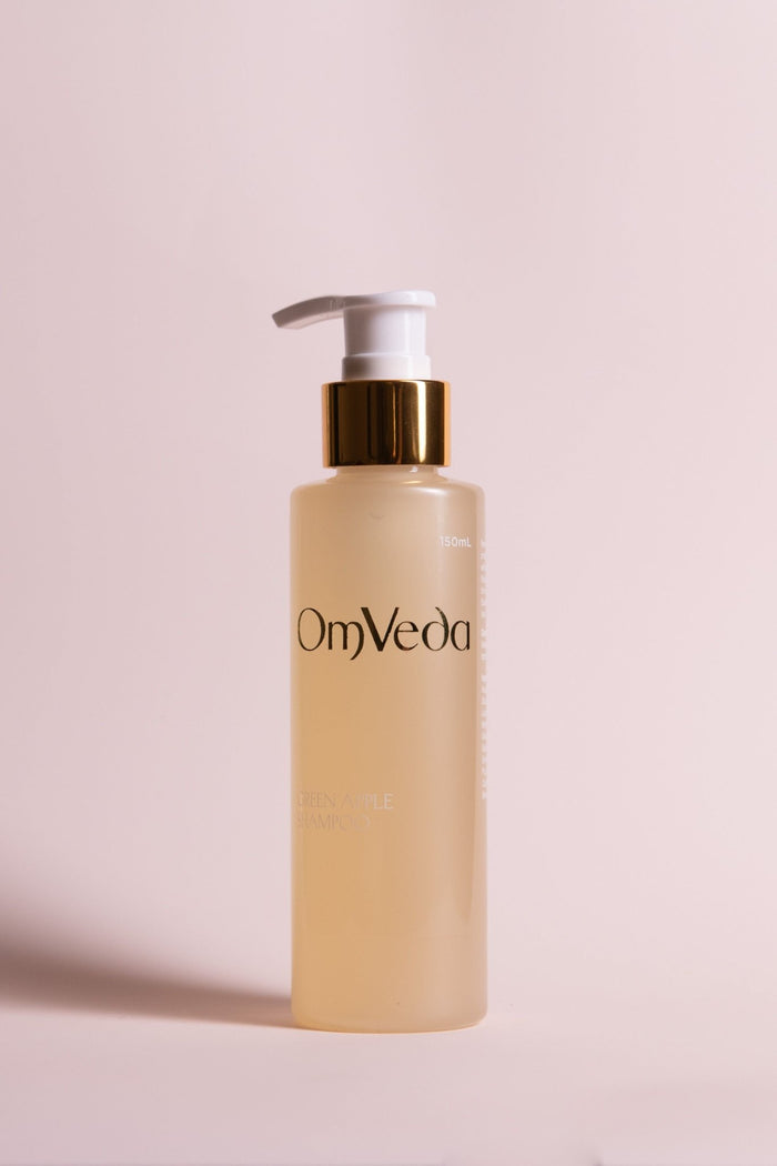 OmVeda Green Apple Shampoo pump bottle with gold cap; amber bottle
