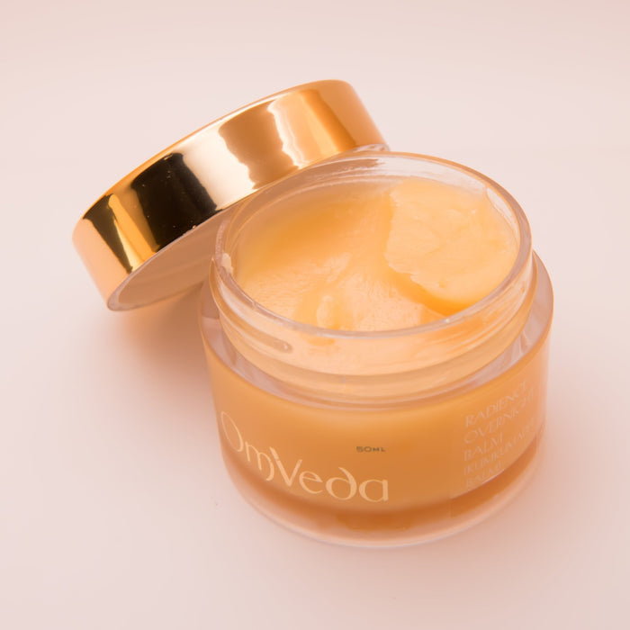 OmVeda Radiance overnight balm jar with creamy balm inside and gold lid