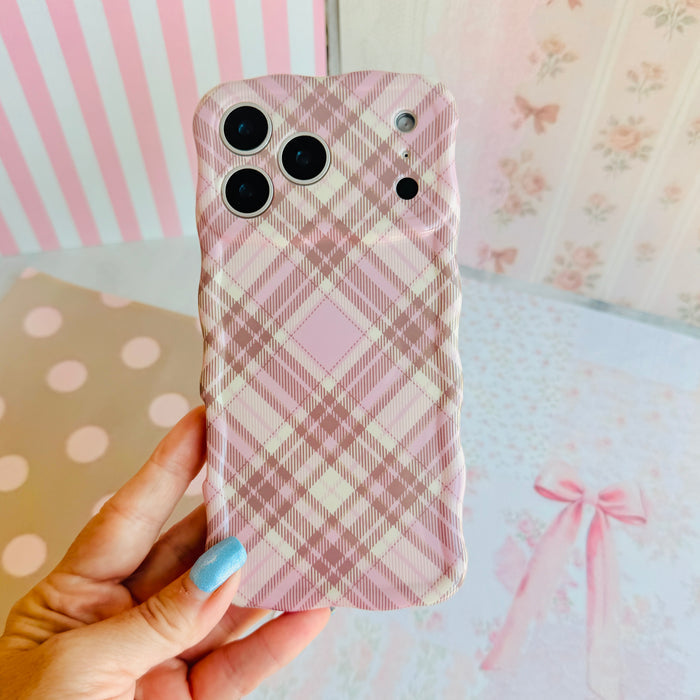 Hand holding the Pink Cashmere Plaid Wavy Luxe MagSafe iPhone case, showing the soft pink and cream tartan check print.