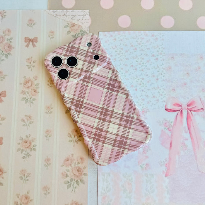 Pink Cashmere Plaid Wavy Luxe MagSafe iPhone case styled on pale pink floral and bow paper, showing the full plaid print.
