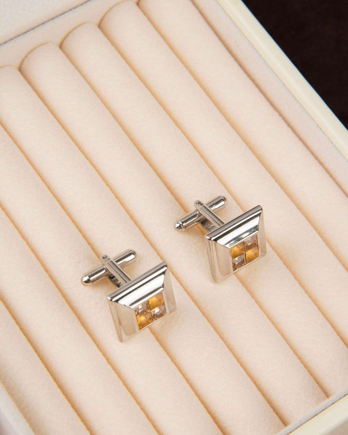 Square silver cufflinks with champagne crystal and bar back, angled view