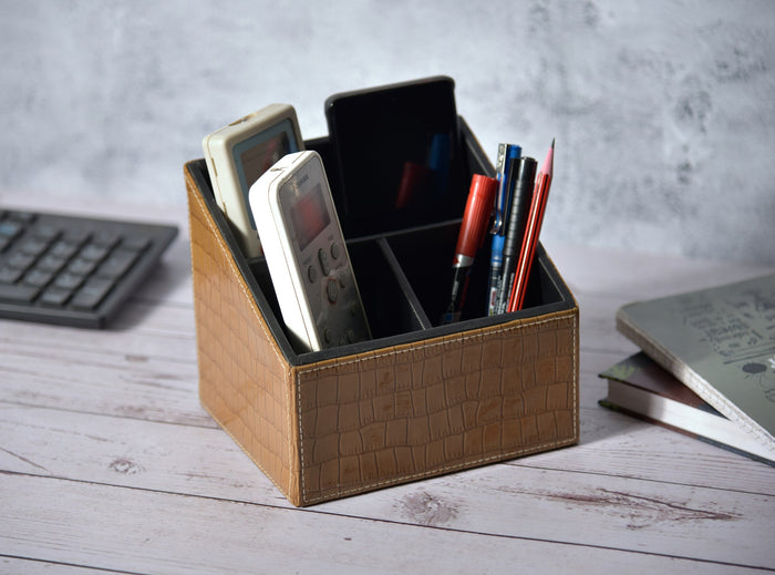 Beige croc-textured remote holder with three compartments, open top for pens and remotes