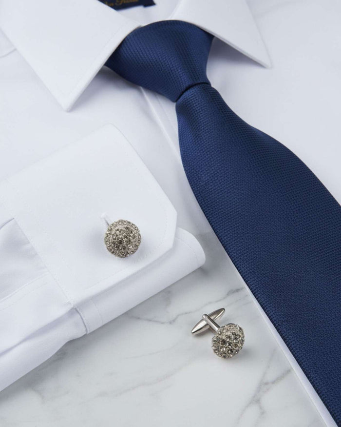 Round silver crystal cufflinks with clustered stones, shown on shirt cuffs