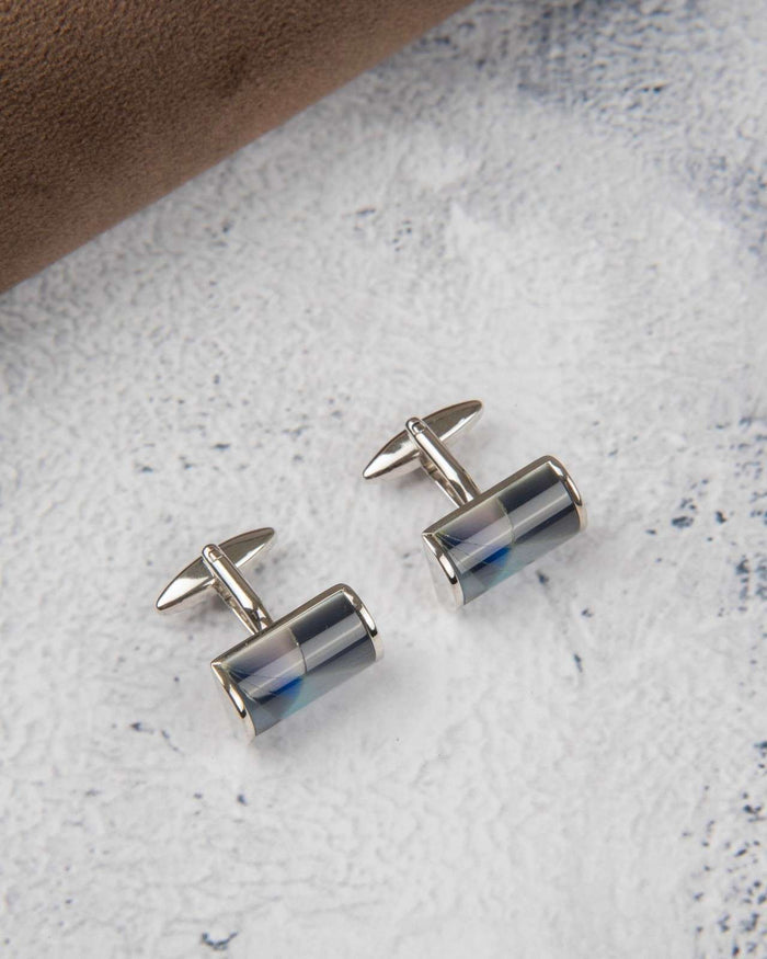 Cylindrical silver cufflinks with dark blue-grey glossy resin center and polished bars