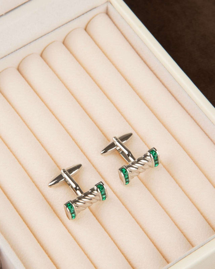 Twisted bar cufflinks with green crystal end caps in a display tray