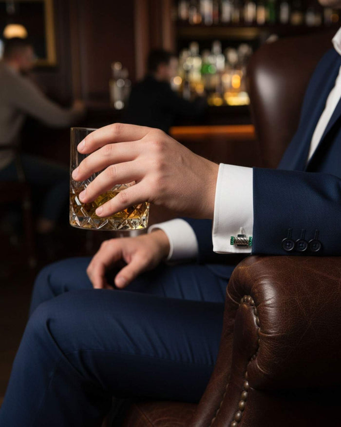 Men’s shirt cuff with twisted bar cufflinks and green crystal end caps