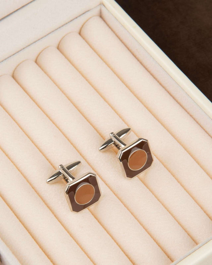Octagon silver cufflinks with brown circular inlay on display tray
