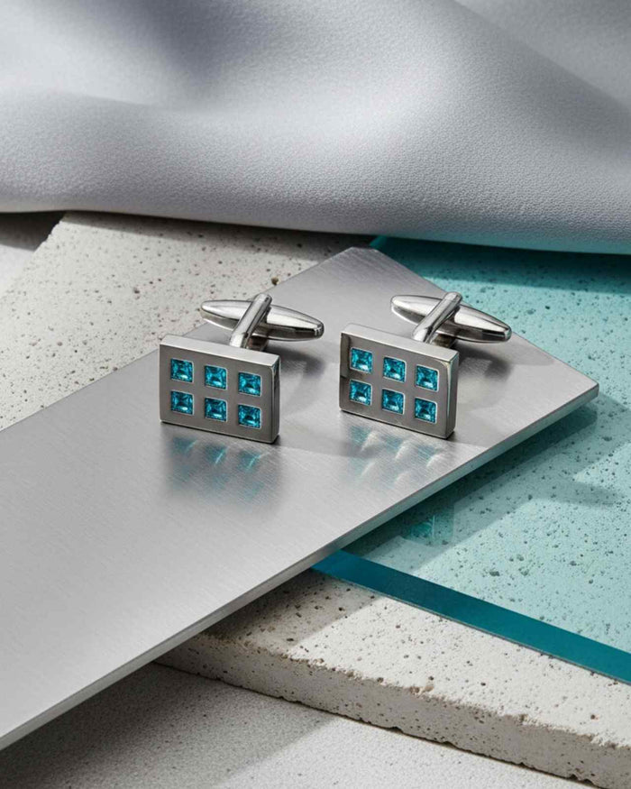 Rectangular silver cufflinks with aqua crystal grid inlay, angled view