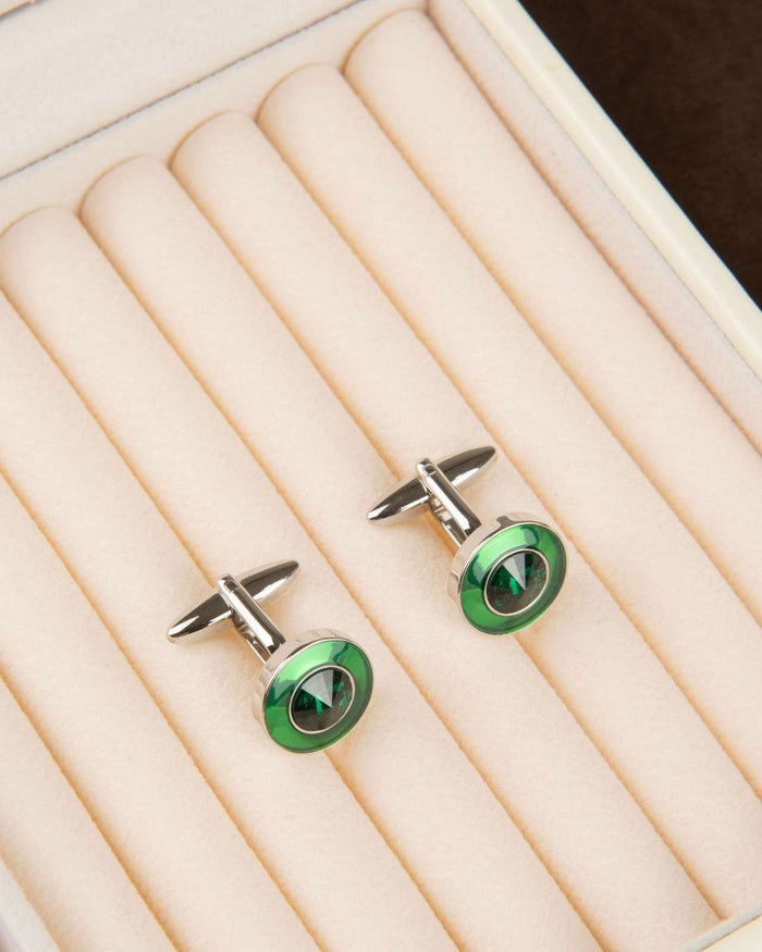 Round green cufflinks with silver posts and circular emerald-look centerpiece