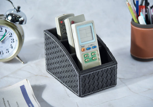 Woven remote holder in dark fabric with 3 compartments holding remotes