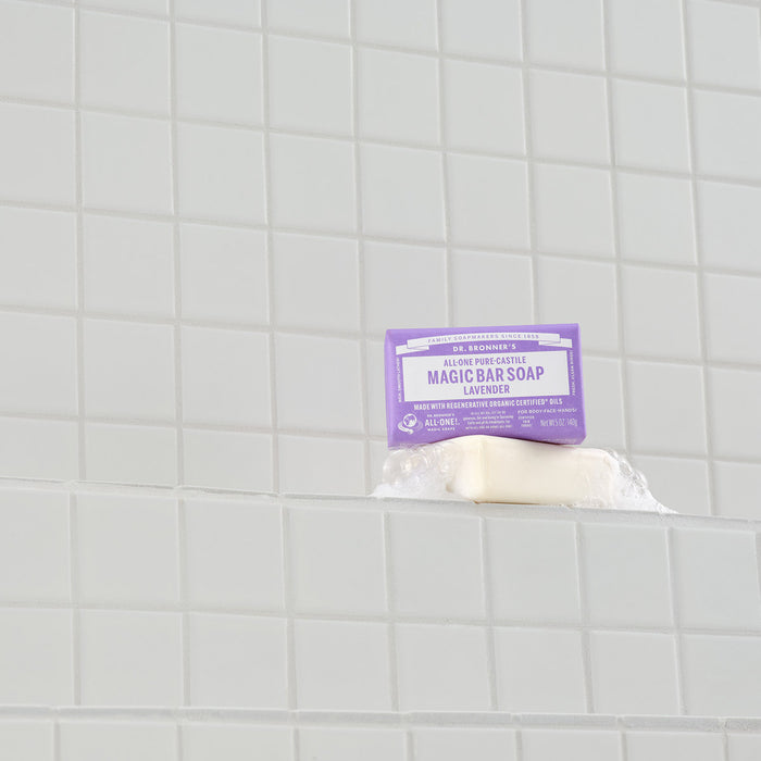 Bar of soap with a purple label on a tiled bathroom wall