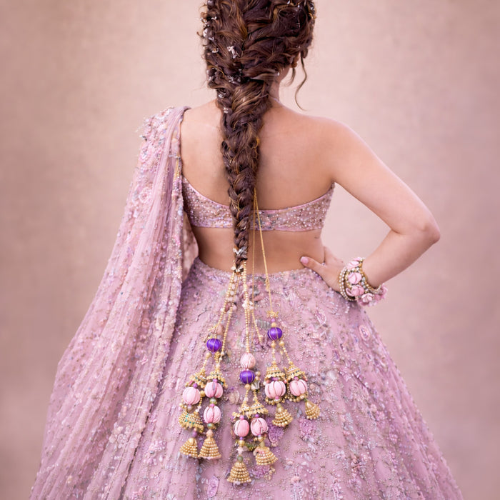 Handcrafted bead and crystal parandi with ghungroos adding movement to long braided hair