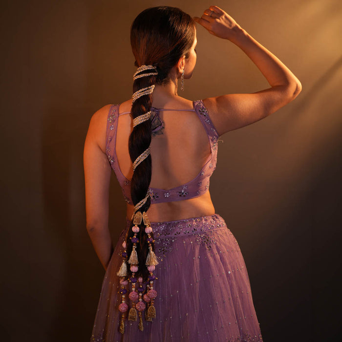 Colourful bridal parandi with tassels, pearls and crystals woven through a sleek braid
