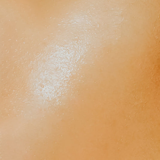 Close-up image of a person's skin, presumably to illustrate the softness achieved by using the fragrance oil.
