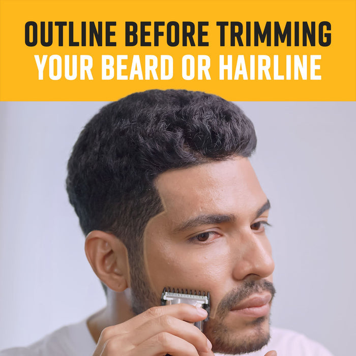 A man using an electric trimmer to follow a beige traced line on his beard and hairline for a precise, professional finish.