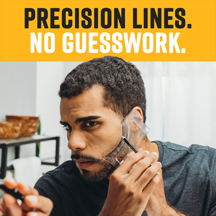 A man looking in a mirror while using a clear plastic shaping tool and a tracing pencil to define his beard line.
