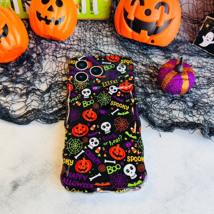 Spooky Wavy Luxe MagSafe iPhone case laid flat on black spiderweb mesh with an orange jack-o-lantern pail and felt pumpkins.