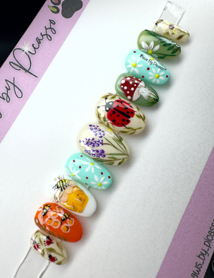 Set of colorful hair pins with floral and nature-themed designs on a white background.