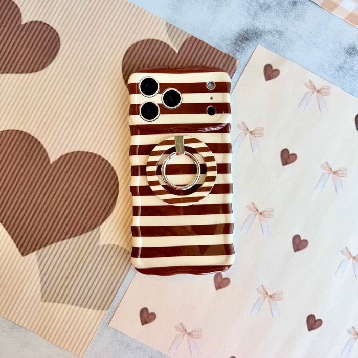 Sweet Espresso Stripes Wavy Luxe iPhone case shown with the matching Sweet Espresso Stripes MagSafe grip ring attached, styled on heart and bow paper.