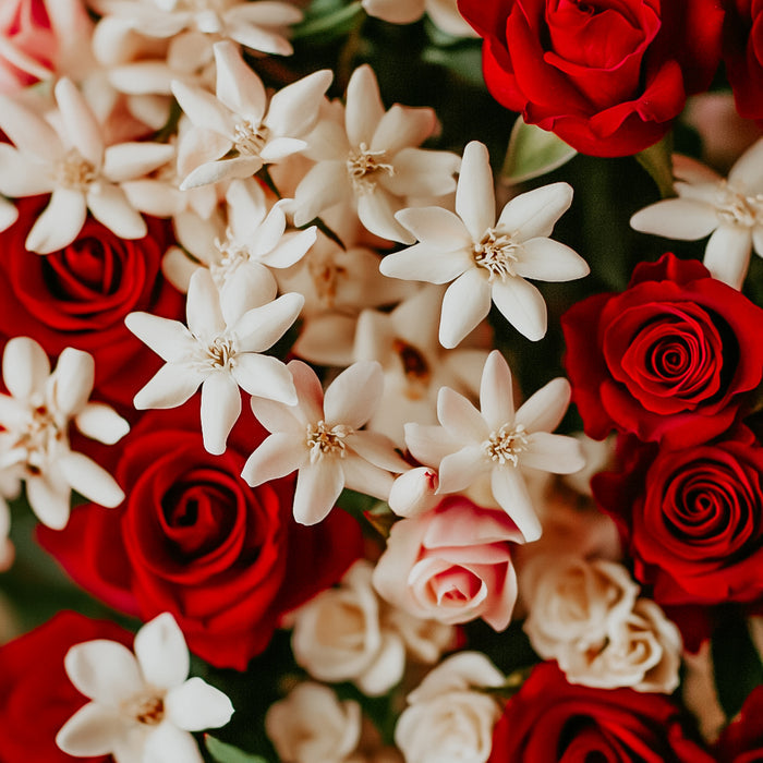 A close-up image of a bouquet with red roses and white flowers, likely representing the fragrance oil's floral scent profile.