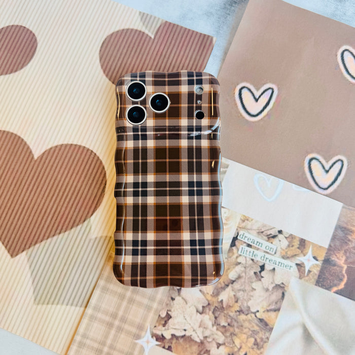 Toffee Tartan Wavy Luxe MagSafe iPhone case styled on brown heart and gingham paper, showing the full tartan check.