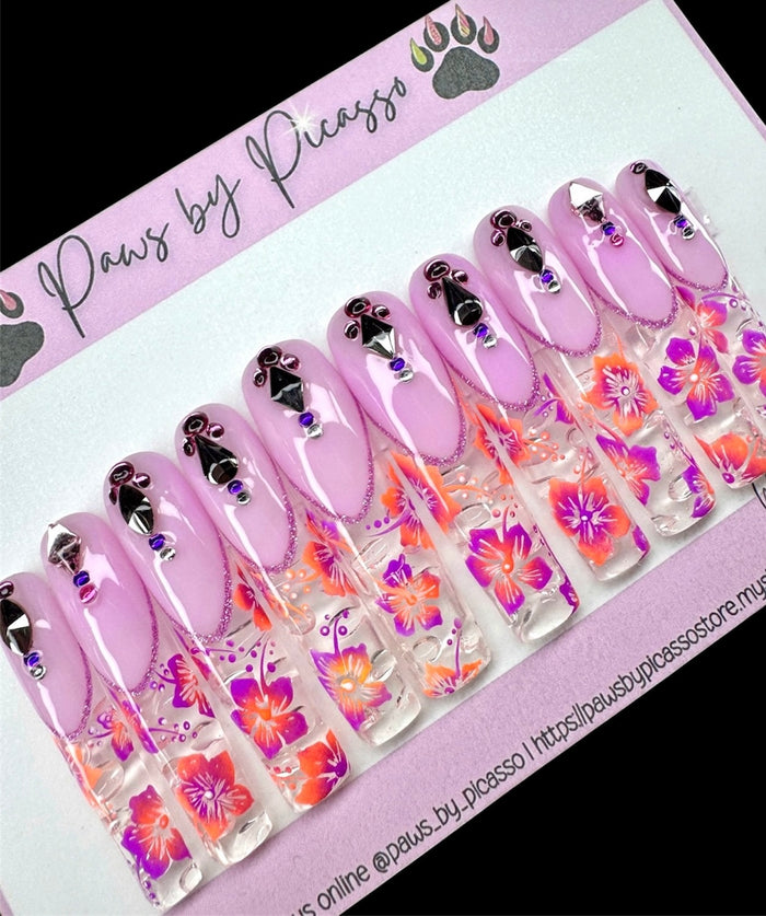 Set of decorative false nails with floral designs on a 'Paws by Picasso' branded card.