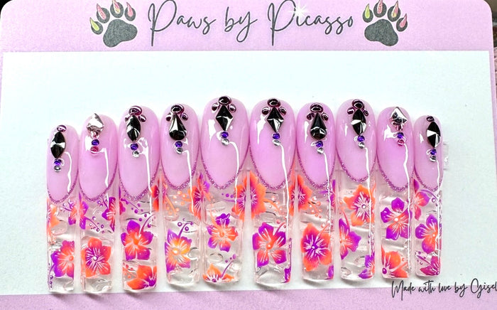 Set of artificial nails with floral design and pink base, branded 'Paws by Picasso'.