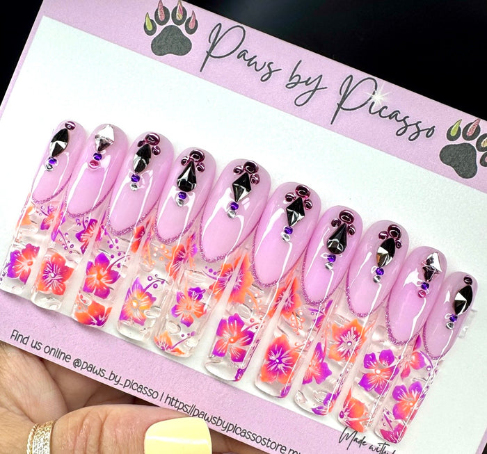 Set of pink nail wraps with floral designs on a 'Paws by Picasso' branded card.